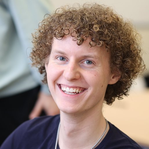 Student lächelt in Kamera.