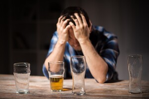 alcoholic drinking beer from glass at night