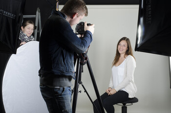Students take photos in the photo studio
