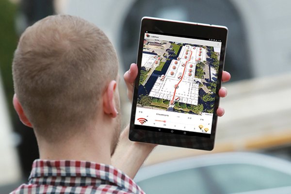 Symbolbild Geoinformatik: Student mit Indoor-Navigations-App auf Tablet